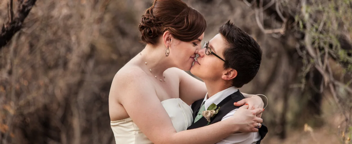 Bride and groom sharing a kiss outdoors