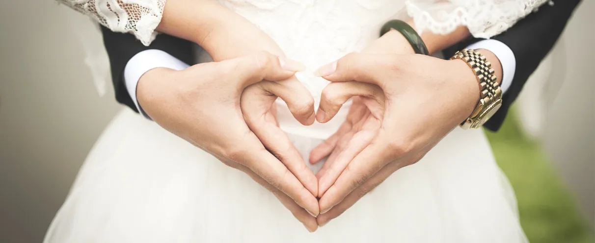 Couple making a heart with their hands