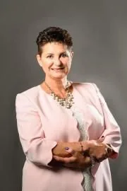 Reverend Jayne in a light pink blazer